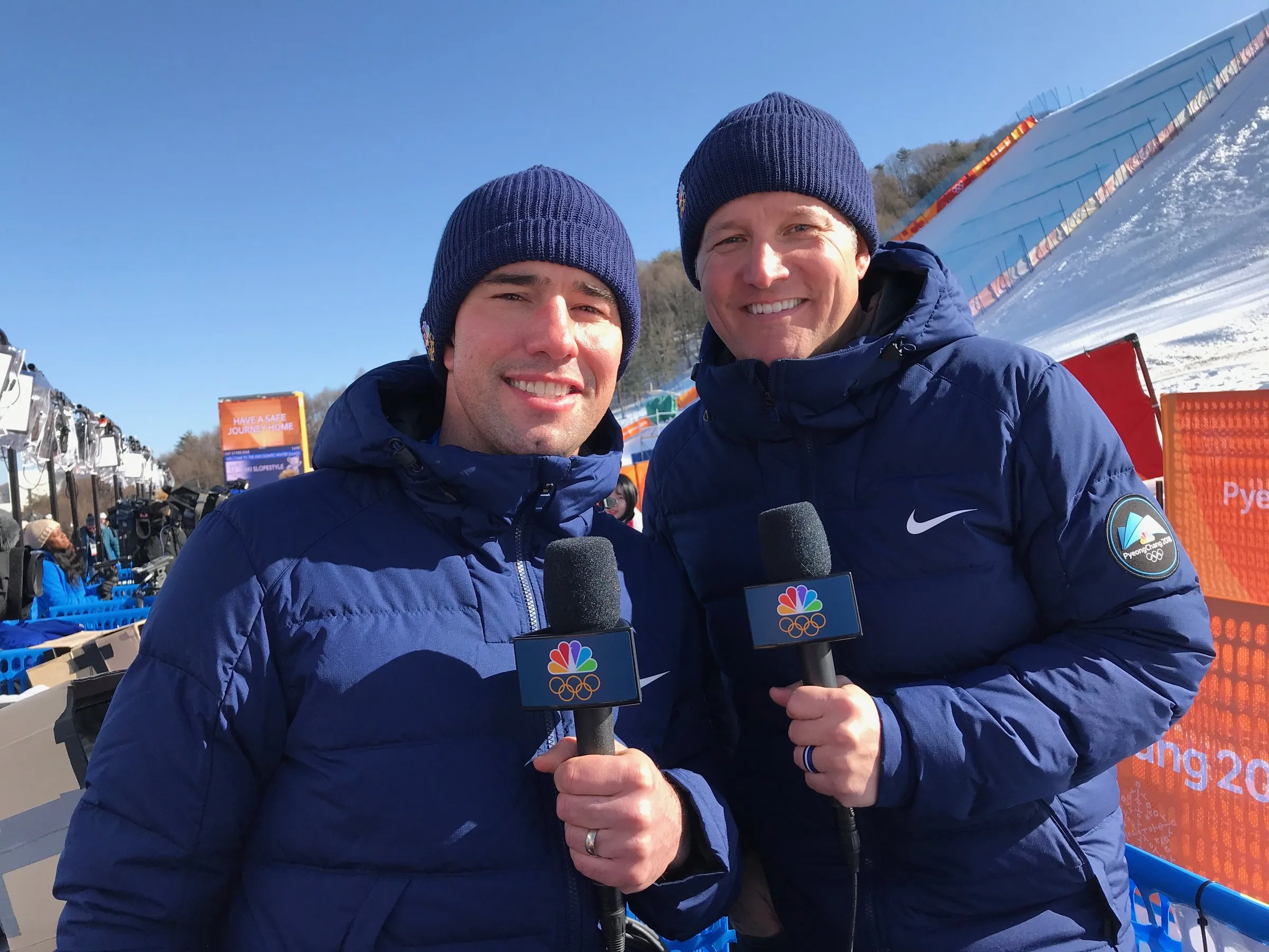 Todd Harris and a colleague in team jackets with microphones at the PyeongChang Games.