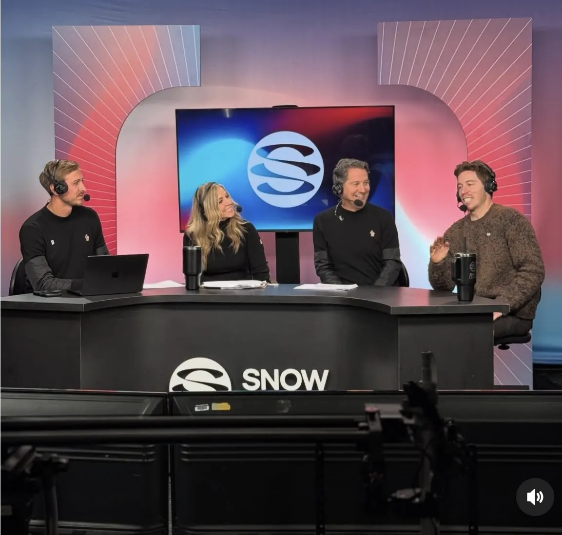Todd Harris at the Snow League studio desk with three co-hosts, mid-broadcast.
