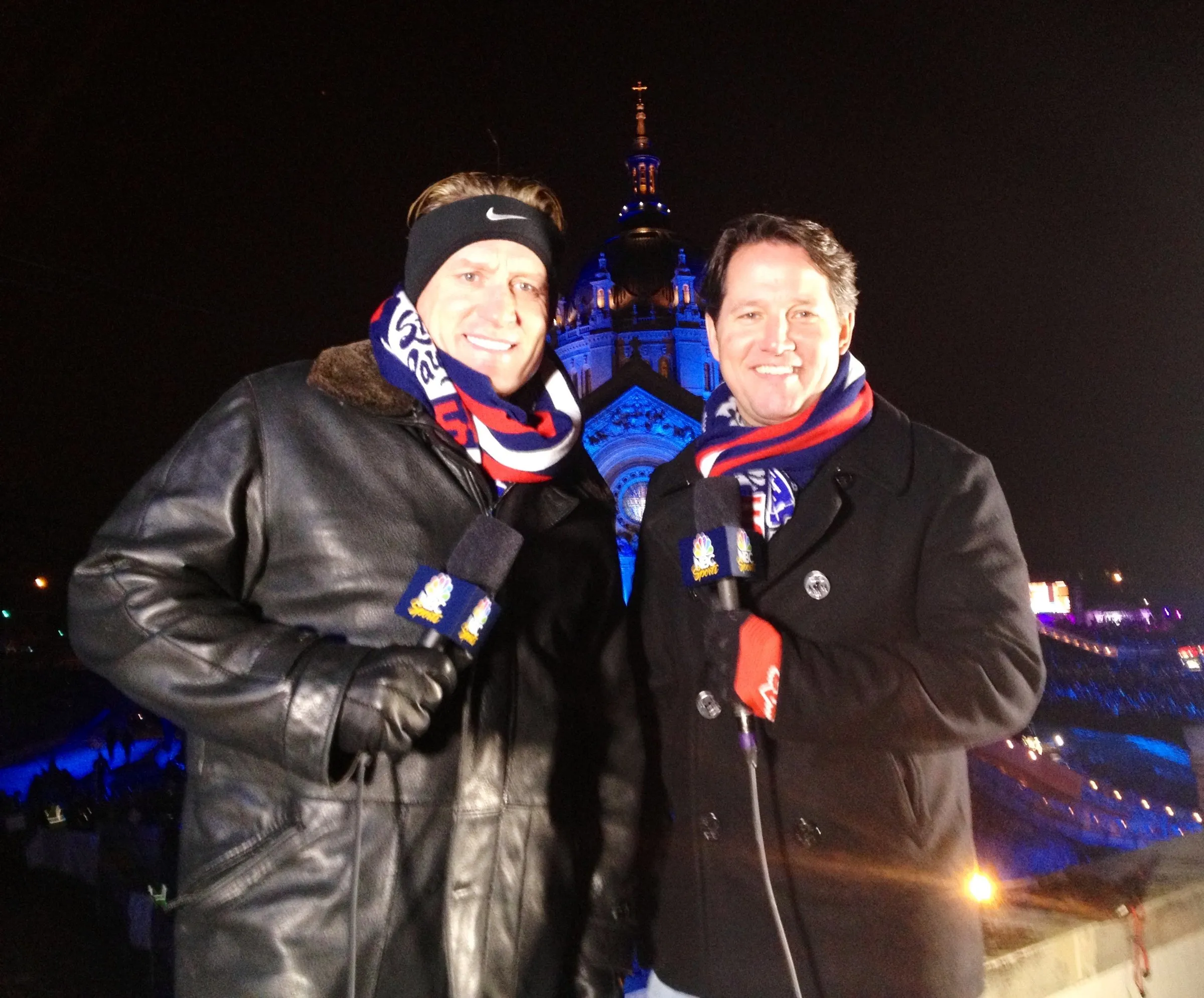 Todd Harris and a colleague in heavy winter kit at a floodlit night venue.